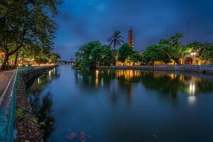 Hanoi, Vietnam - 25 Jun 2024 Tran Quoc Pagoda, the oldest Buddhist temple in Hanoi, is located on a small island near the southeastern shore of West Lake, Hanoi, Vietnam. photo