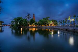 Hanoi, Vietnam - 25 Jun 2024 Tran Quoc Pagoda, the oldest Buddhist temple in Hanoi, is located on a small island near the southeastern shore of West Lake, Hanoi, Vietnam. photo