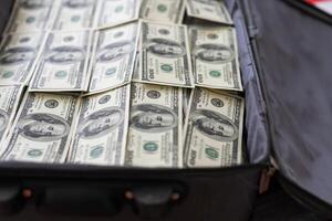 100 dollar bills in a suitcase photo