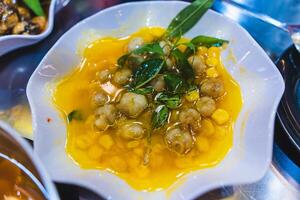 Stir fried water spinach with snails served in dish isolated on grey background top view of seafood photo