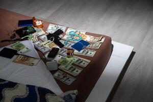 Evidence Chain of Custody Labels and brown paper bag with fingerprints applicant card lies against big heroin packets and packs of money bills as evidence in crime scene investigation process photo