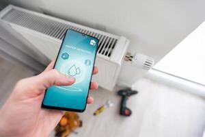 Close up focus on cellphone with smart home software application on screen, wireless light music temperature regulation with digital gadget, air conditioner climate control, iot, virtual assistant photo