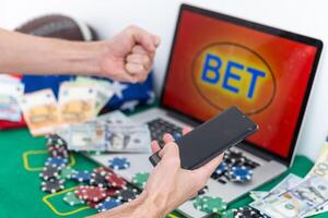 a mobile phone shows a betting application with live results and updates with white background. Online betting concept. photo