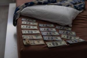 Evidence Chain of Custody Labels and brown paper bag with fingerprints applicant card lies against big heroin packets and packs of money bills as evidence in crime scene investigation process photo
