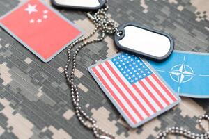 army blank, dog tag with flag of nato and vietnam on the khaki texture background. military concept. High photo
