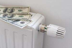 gas bill in front of heating radiator. Payment for heating in winter. photo