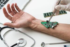 The man shows his hand with a chip implanted. The concept of chipping and implantation of electronic technologies into the human body. Cybernetics and the nanofuture photo