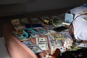 Evidence Chain of Custody Labels and brown paper bag with fingerprints applicant card lies against big heroin packets and packs of money bills as evidence in crime scene investigation process photo