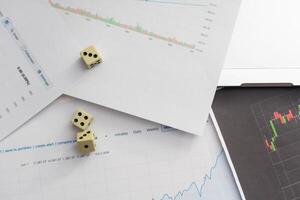 Dices cubes to trader. Cubes with the words SELL BUY on financial chart and columns of quotations as background. Selective focus photo