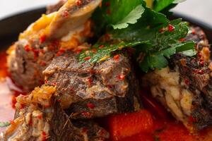 Soto Tangkar is Betawi food. The name Tangkar itself is a term for beef ribs in Betawi language. Soto Tangkar cooked in thin coconut milk soup spiced with red curry. photo