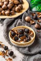 Fermented black garlic. The color is a result of the Maillard reaction or caramelization. Black garlic can help to regulate blood sugar levels photo