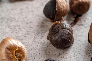 Fermented black garlic. The color is a result of the Maillard reaction or caramelization. Black garlic can help to regulate blood sugar levels photo