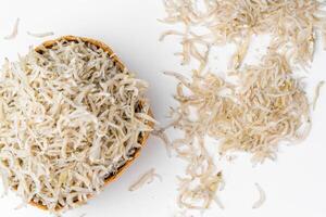 Fresh dried anchovies on White Background. Raw dry salted sea fish. saltwaterforage fish. Ikan asin teri medan. photo