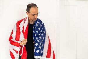 Man standing and putting country flag around the shoulder photo