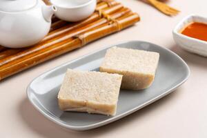 Turnip cake or Chai tow kway. Turnip cake is a common dish or dim sum of Teochew cuisine in Chaoshan, China usually cut into rectangular slices and sometimes pan fried before serving photo