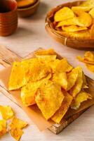 Breadfruit chips or Keripik sukun are food made from breadfruit which is thinly sliced and then fried until dry and crispy. It tastes salty and is usually given a savory onion aroma. photo