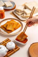 Turnip cake or Chai tow kway. Turnip cake is a common dish or dim sum of Teochew cuisine in Chaoshan, China usually cut into rectangular slices and sometimes pan fried before serving photo