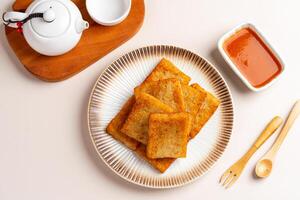 Turnip cake or Chai tow kway. Turnip cake is a common dish or dim sum of Teochew cuisine in Chaoshan, China usually cut into rectangular slices and sometimes pan fried before serving photo
