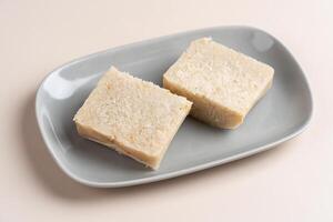 Turnip cake or Chai tow kway. Turnip cake is a common dish or dim sum of Teochew cuisine in Chaoshan, China usually cut into rectangular slices and sometimes pan fried before serving photo