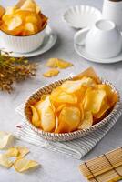 Cassava chips, a traditional Indonesian snack, are made from thin slices of cassava and then dry fried sprinkled with salt photo