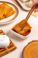 Turnip cake or Chai tow kway. Turnip cake is a common dish or dim sum of Teochew cuisine in Chaoshan, China usually cut into rectangular slices and sometimes pan fried before serving photo