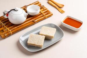 Turnip cake or Chai tow kway. Turnip cake is a common dish or dim sum of Teochew cuisine in Chaoshan, China usually cut into rectangular slices and sometimes pan fried before serving photo