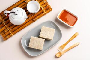 Turnip cake or Chai tow kway. Turnip cake is a common dish or dim sum of Teochew cuisine in Chaoshan, China usually cut into rectangular slices and sometimes pan fried before serving photo
