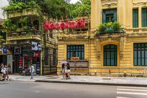 Hanoi, Vietnam - 26 June 2024 Hanoimoi newspaper check-in point near by Hoan Kiem lake. People have exercise in the morning on Ho Guom lake photo