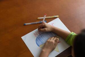 Ukrainian flag and a heart in yellow and blue color. Child draws a heart on the blackboard photo