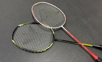 Competitive sports and high performance in tournament match conceptual idea with badminton rackets and shuttlecock with copy space photo