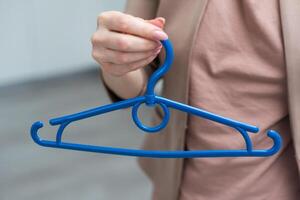 hand holding an empty cloth hanger photo