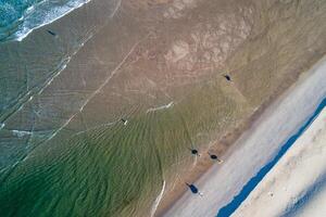 drone aerial view of a turquoise water beach at dawn photo
