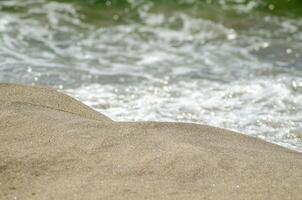 selective focus, close-up view of the shore of a beach photo