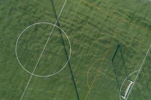 drone aerial view of an artificial grass soccer field at dusk photo