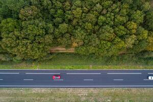 drone aerial top view of a red car in a highway photo