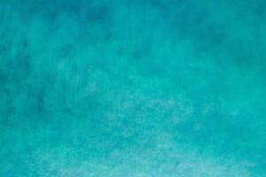 Aerial view of a clear sea water texture. View from above Natural turquoise background, green water reflection. photo