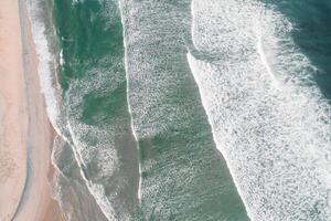 Beach and waves from top view. Turquoise water background from top view, aerial summer seascape top view from drone. Travel concept and idea photo