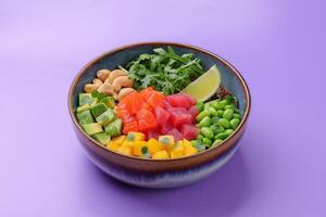 Top view of a colorful salmon poke bowl with fresh vegetables and rice, presented photo