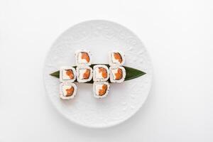 Close-up of sushi rolls made of sausage and covered with cabbage and ketchup. Homemade asian style. Sushi-food hybrids trend. Japanese food photo
