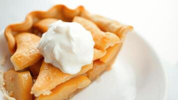 Close up of a slice of peach pie with whipped cream photo