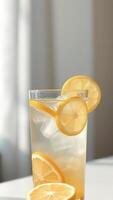Lemonade with lemon slices and ice cubes in a glass photo