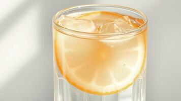 Glass of Refreshing Lemonade with Lemon Slice and Ice photo