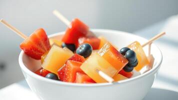 Close-up of a bowl of fresh fruit salad with blueberries, strawberries and pineapple photo