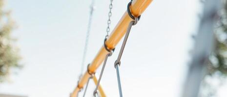 Close-up of a swing set with blurred background photo