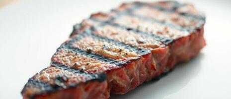 Close-up of a Grilled Steak on a White Plate photo