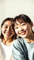 Portrait of two young women smiling and looking at the camera photo