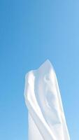 White fabric against a blue sky photo