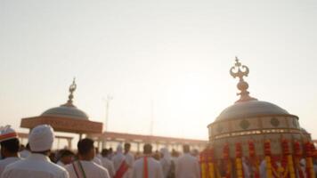 Blurred image of a religious procession with a bright sun behind photo