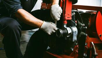 Mechanic working on a red tractor photo