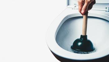 Closeup of Hand Using Plunger in Toilet Bowl photo